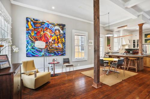a living room with a large painting on the wall at Eclectically furnished home in the heart of NOLA in New Orleans