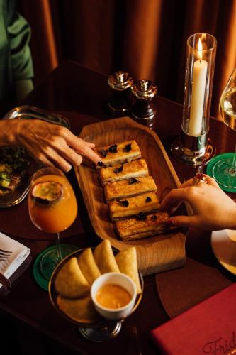 a table with a tray of bread and a plate of food at Maison Barrière Vendôme in Paris