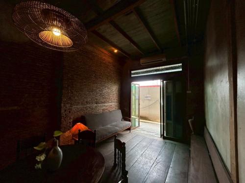 a living room with a couch and a table at Yellow House in Bangkok