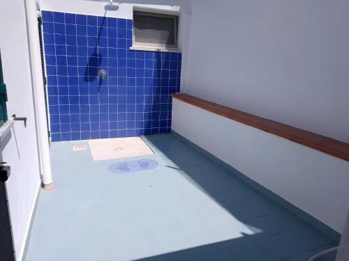 a bathroom with a blue tile floor and a shower at Casa Vista Mare con Giardino in Praia a Mare