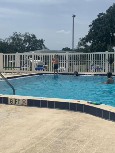 a person is standing in a swimming pool at Unique Adventure Awaits in This Custom Tour Bus Conversion! in Clermont
