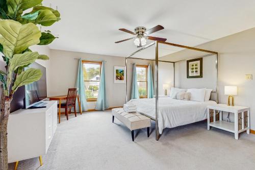 a bedroom with a bed and a ceiling fan at The Carriage House in Harwich