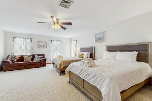 a bedroom with two beds and a ceiling fan at The Carriage House in Harwich