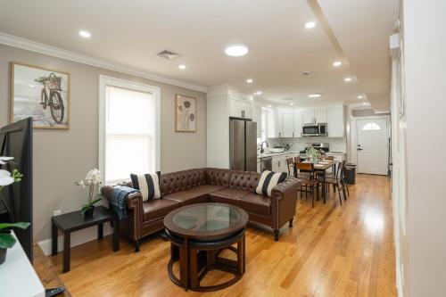a living room with a couch and a table at 558-1 Boston - Spacious & Modern 3BR near Franklin Park in Boston