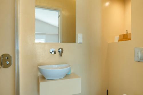 a bathroom with a sink and a mirror at Artemida Beach House in Artemida