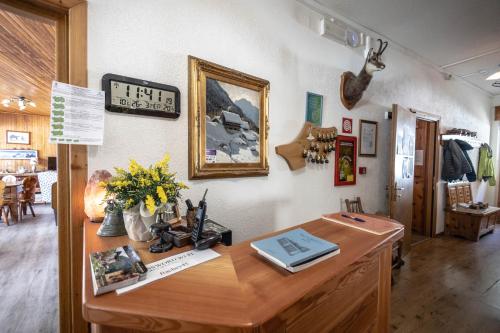 a room with a wooden desk with flowers on it at Hotel Le Campagnol in Champoluc