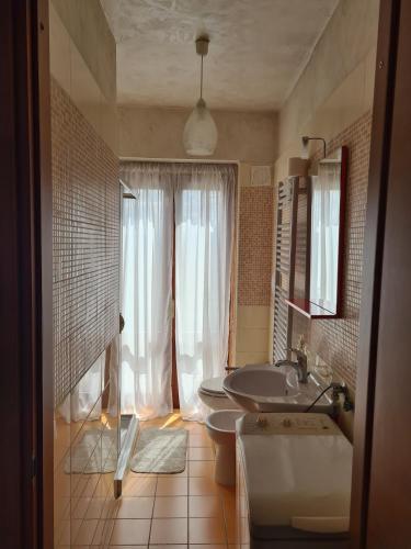 a bathroom with a tub and a sink and a mirror at La bella vista in Conocchia