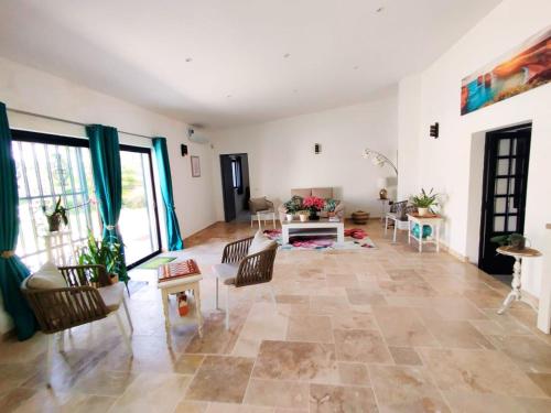a large living room with a table and chairs at Quinta Azul in Loulé