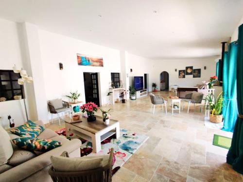 a living room with a couch and a table at Quinta Azul in Loulé