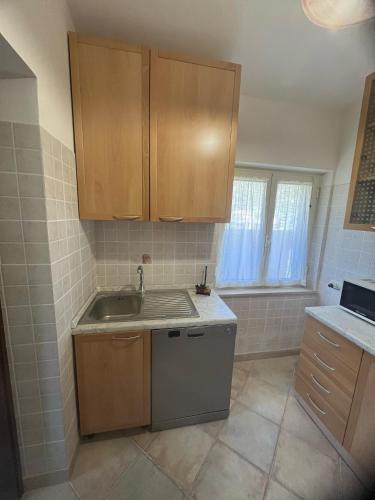 a kitchen with wooden cabinets and a sink at Il Belvedere in Casperia