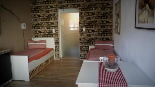 a living room with two beds and a table at Ferienwohnung "HeX N-STuBe" in Weißenburg in Bayern