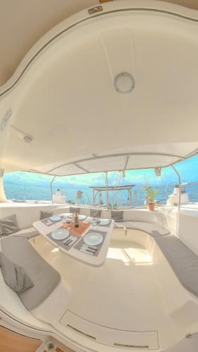 a white boat with a table on top of it at Enjoy Sailing Experience in El Porvenir