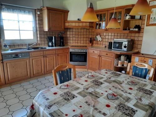 a kitchen with a table with a table cloth on it at Ferienhaus vor den Toren Greetsiels in Krummhörn