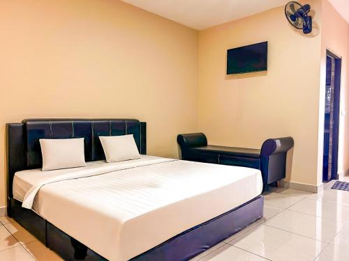 a bedroom with a large bed and a chair at Tekoma Resort Cameron Highlands in Tanah Rata