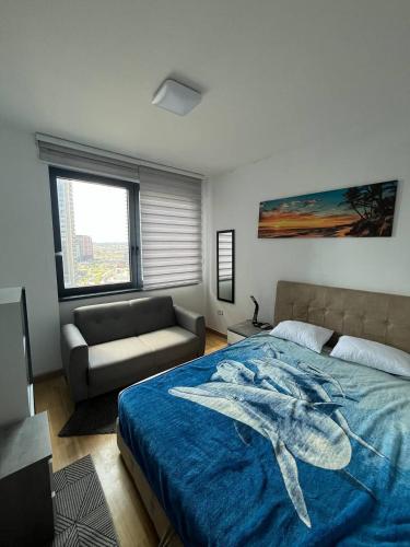 a bedroom with a large bed and a couch at BW St Lui Apartment in Belgrade