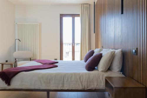 a bedroom with a large bed with a window at Hotel Ristorante Da Politano in Boves
