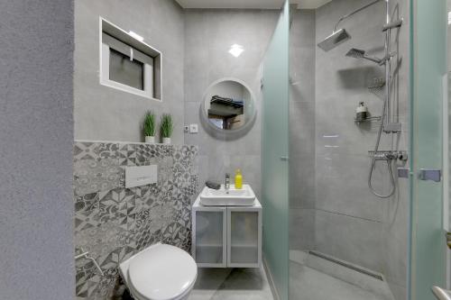 a bathroom with a shower and a toilet and a sink at Lovely 2-bedroom apartment in centre of Bratislava in Bratislava