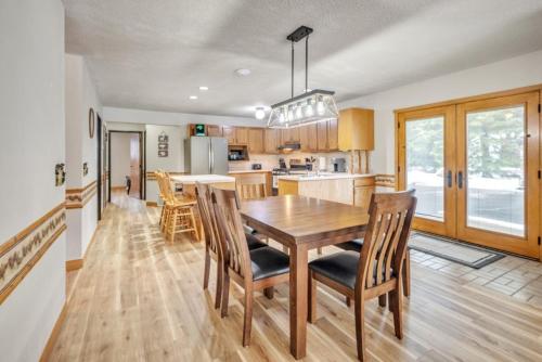 a kitchen and dining room with a wooden table and chairs at Boulder Junction Motor Lodge in Boulder Junction