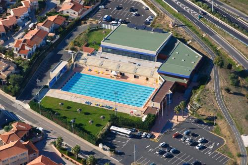 an overhead view of a building with a swimming pool at Malibu Village in Canet-en-Roussillon