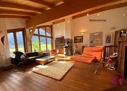 a living room with a couch and a table at Panoramachalet Tirolernaturschlaf in Wildschönau