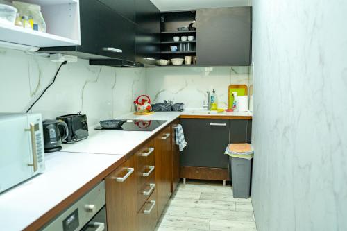 a kitchen with white counter tops and brown cabinets at Penzión Oliver Humenné in Humenné