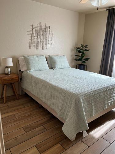 a bedroom with a large bed and a potted plant at Our Cozy Home Fully Equipped in Yuma
