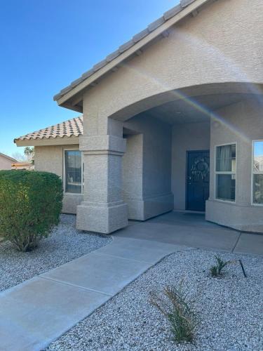 a house with a driveway leading to a front door at Our Cozy Home Fully Equipped in Yuma