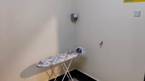 a hospital bed in a room with a thermometer at Sky View Hotel Dengkil Putrajaya Cyberjaya in Kampung Dengkil