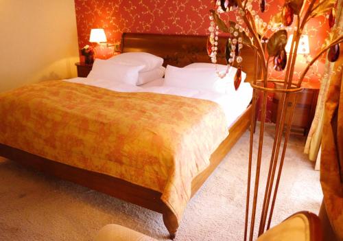 a bedroom with a large bed with at Villa Hammerschmiede in Söllingen