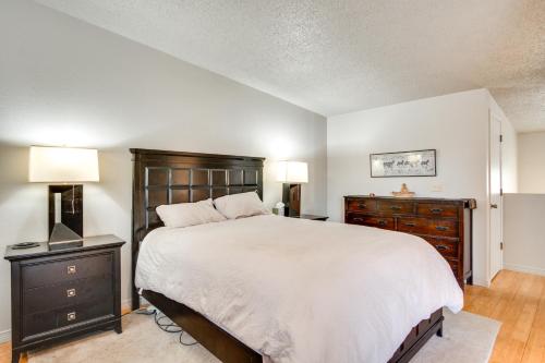 a bedroom with a bed and a dresser and two lamps at Pet-Friendly Tucson Townhome with Pool Access! in Tucson