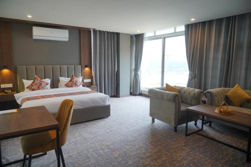a hotel room with a bed and a couch at Destination Hotel Gilgit in Gilgit