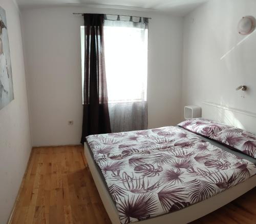 a bedroom with a bed and a window at Apartment Anita in Fažana