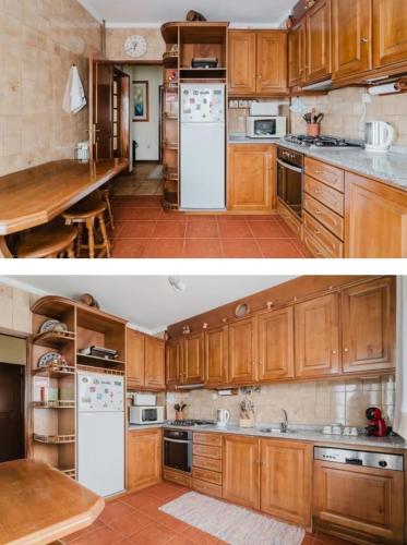 a kitchen with wooden cabinets and white appliances at Quartos para Férias - Apúlia in Apúlia