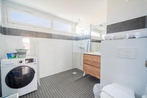 a bathroom with a washing machine and a sink at Centre Jean XXIII in Annecy