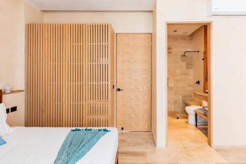 a bedroom with a bed and a bathroom with a shower at Xaana Private Pool 2 bed wifi 300 Mbps Rooftop in Tulum
