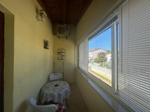a bathroom with a toilet and a large window at Apartments Silvi in Medulin