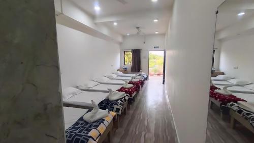 a row of beds in a room with mice on them at AamraKunj Gir Resort in Sasan Gir