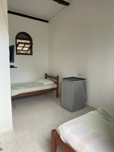 Ein Bett oder Betten in einem Zimmer der Unterkunft Raízes Pousada