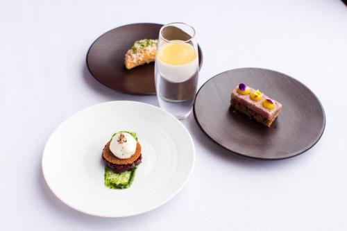 a table with plates of food and a glass of milk at The Club Hotel & Spa Jersey in Saint Helier Jersey