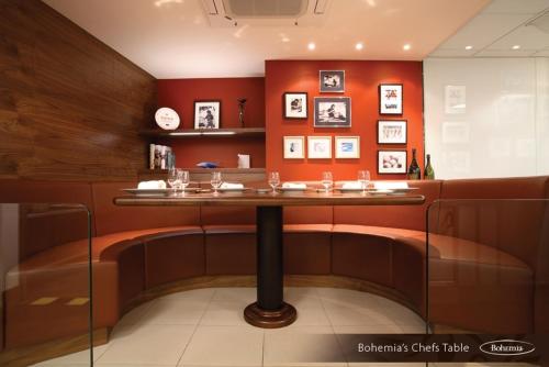 a bar in a restaurant with red walls at The Club Hotel & Spa Jersey in Saint Helier Jersey