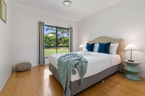 a bedroom with a bed and a large window at 4BSpacious Cozy Family Entertained home at Parkinson in Browns Plains