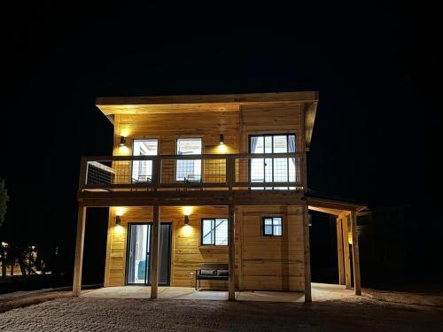 a small wooden house with lights on it at night at Tiny Cabin #7 at The Cedars in Kanab