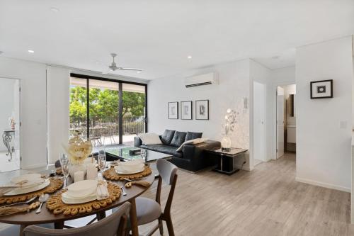 a white living room with a table and chairs at Perfect Spot Near CBD n UQ Spacious 2Beds Apt in Brisbane