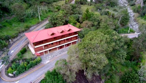 an overhead view of a building with a red roof at The Lookout Hideaway in Baños