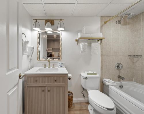 a bathroom with a sink toilet and a mirror at Bella Vista Suites Lake Geneva in Lake Geneva