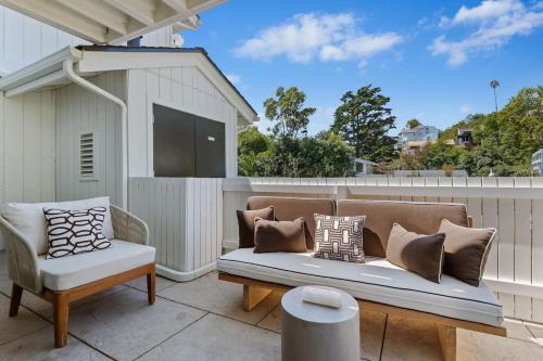 a couch and a chair on a patio at Jasmine Hideaway and Newly Renovated in Summerland