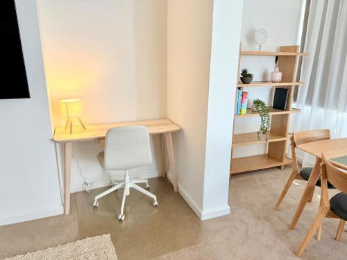 a room with a desk and a chair and a table at Serviced Luxury Condo, Parkside, moments to metro in Sydney