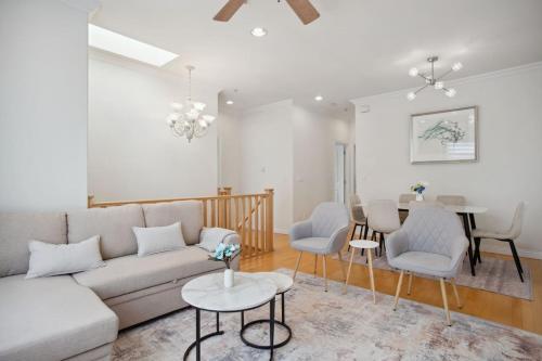 a living room with a couch and chairs and a table at Bright and Comfy 3BR Home Ideal for Families in Vancouver