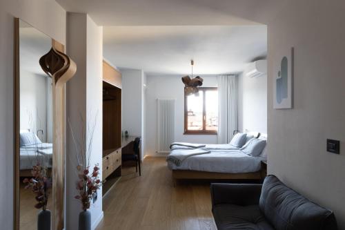 a living room with two beds and a couch at Hotel Ristorante Da Politano in Boves