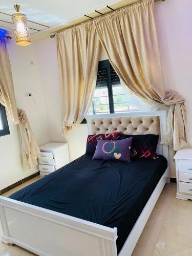 a bedroom with a large bed with a window at Al confort in Fez